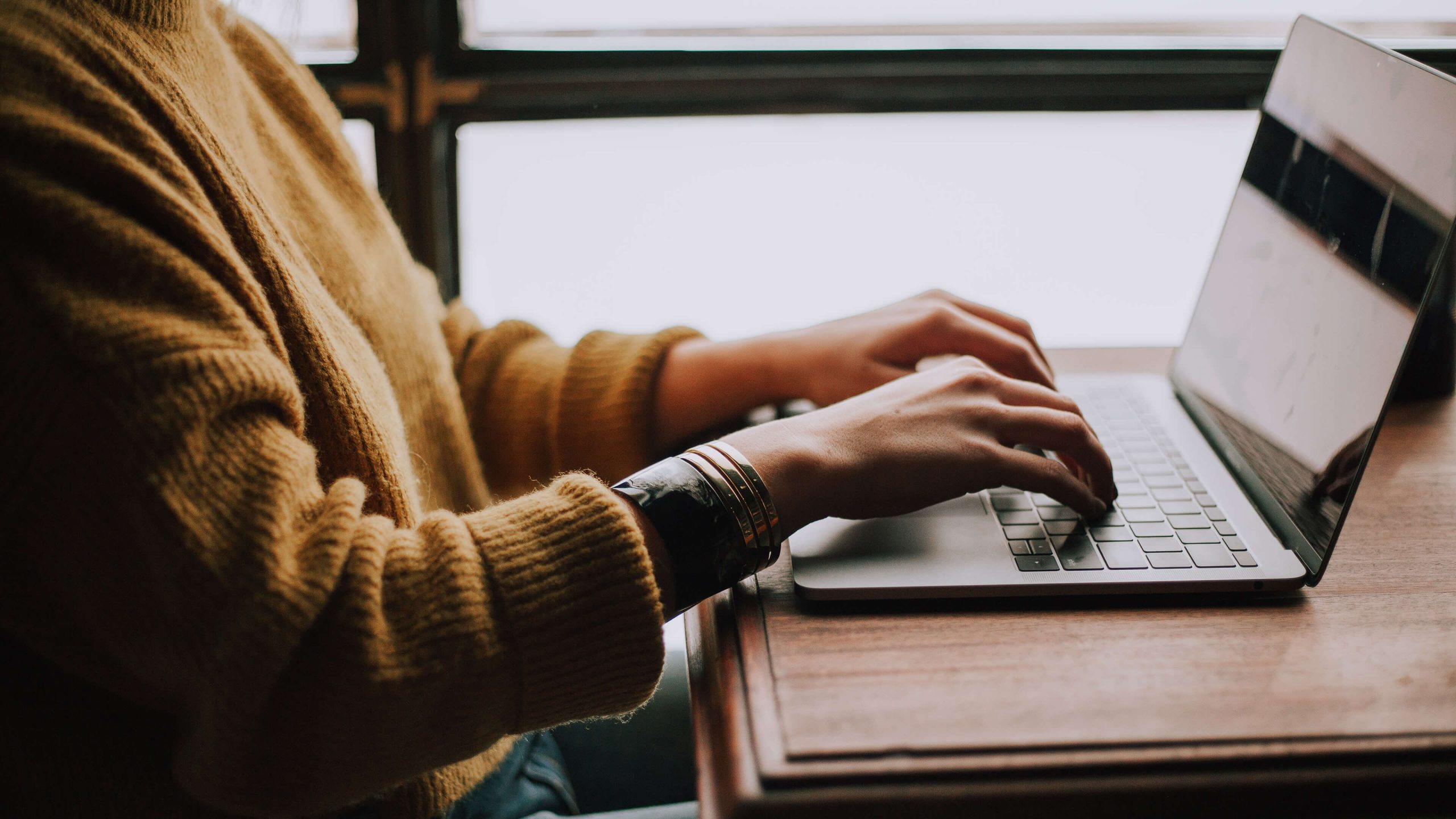 Person seating at a table working on computer